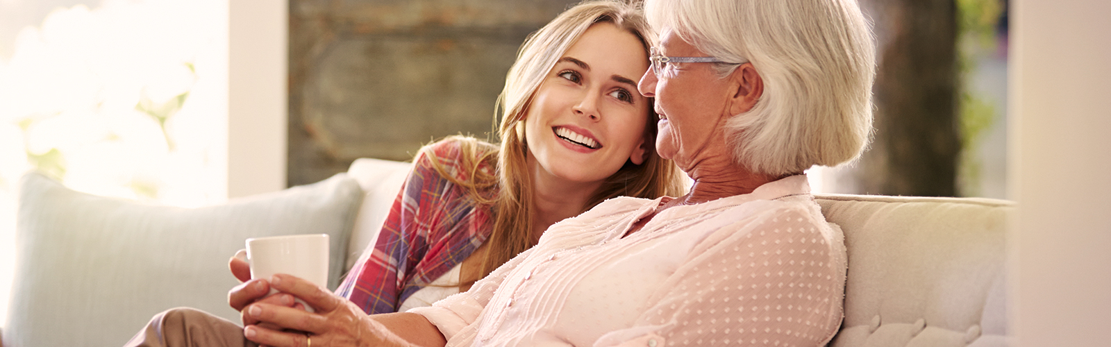 Younger woman and older woman enjoying tea Younger woman and older woman enjoying tea